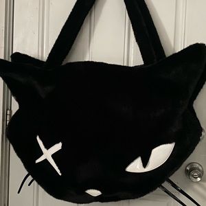 Dolls kill head of a cat tote bag.